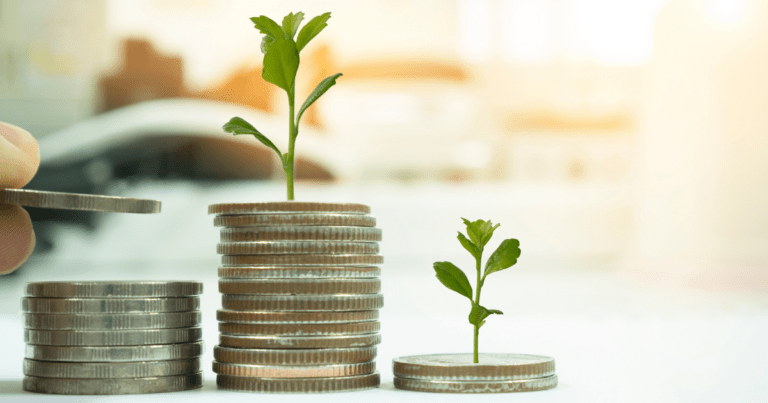 Three stacks of coins with plants growing from the coins